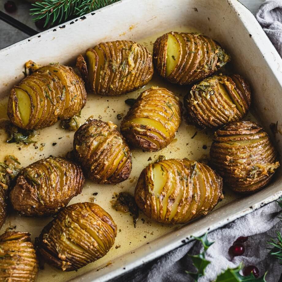 Sticky roast garlic and rosemary new potatoes recipe / Riverford