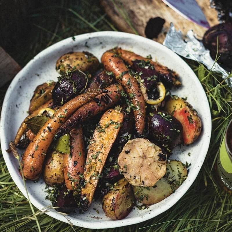 Emberbaked roots with garlic and carrot tops recipe / Riverford