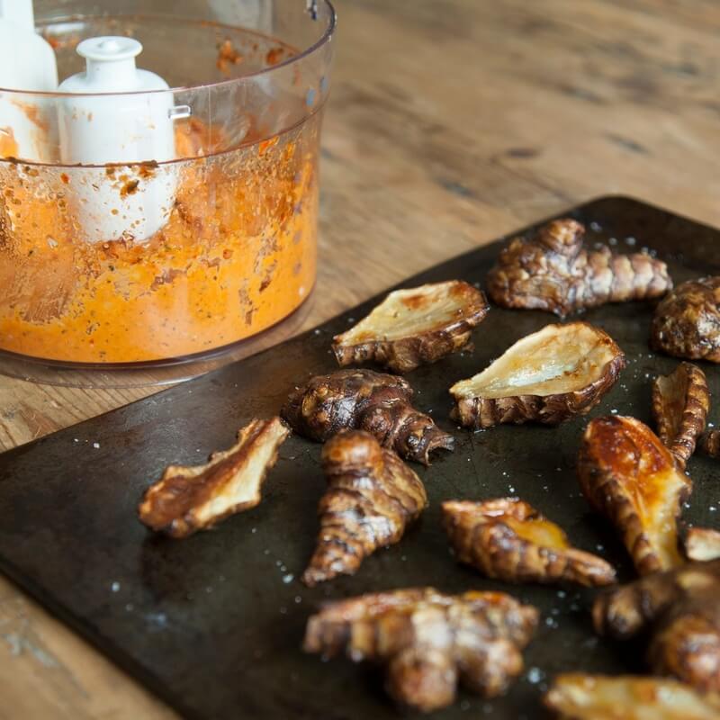 Roasted Jerusalem artichokes with romesco sauce recipe / Riverford