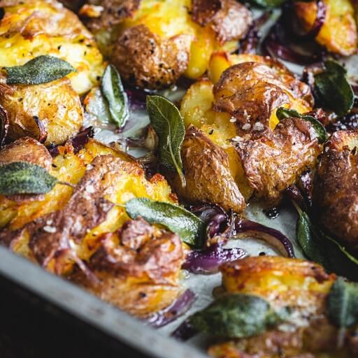 Smashed potatoes with onion and sage recipe / Riverford